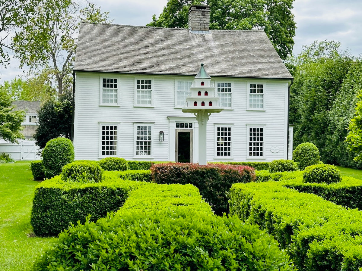 Historic Houses of Essex, walking tour of Essex, CT. Noah Tooker House, Essex, CT. Historic white house with green hedges in front and a historic dove house. Iconic.