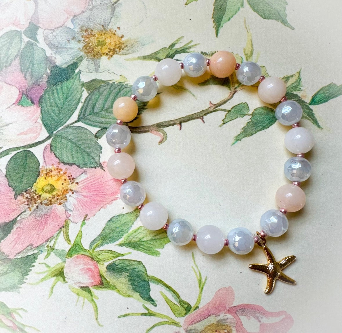 Bracelet with starfish charm on floral background