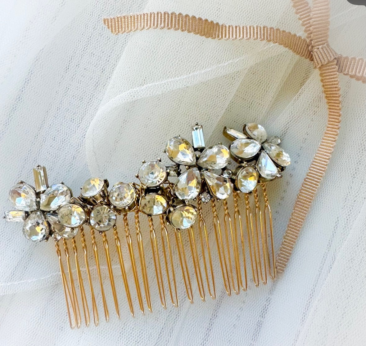 Gold hair comb with crystal stones on a white background