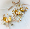 Gold and pearl hairpiece with decorative elements on a white background